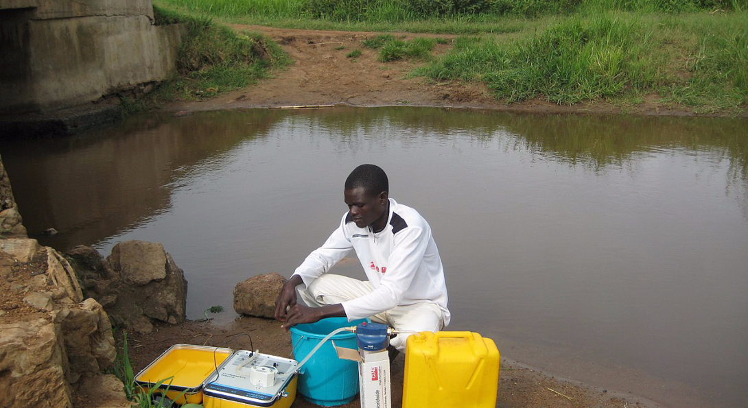 A disease detective in Uganda takes water samples to test for water-borne disease.