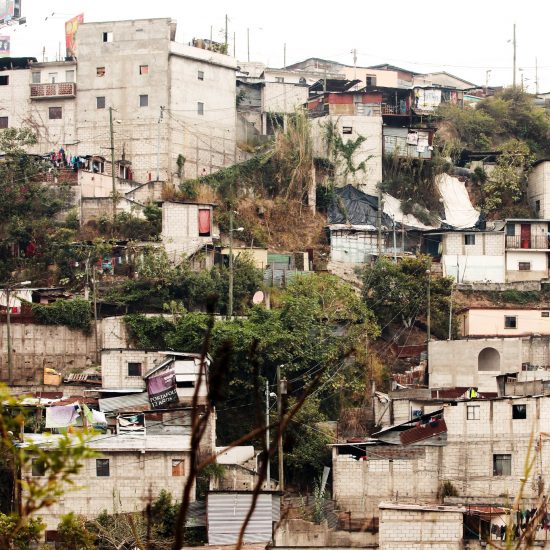 Small homes rise up on a hill in Guatemala City, Guatemala.